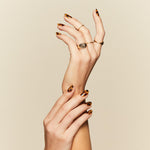Cat's Meow tortoiseshell pattern press-on nails by Mani Muse, close-up hand shot.