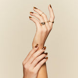 Cat's Meow tortoiseshell pattern press-on nails by Mani Muse, close-up hand shot.
