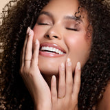 Half Past Nude neutral nude press-on nails by Mani Muse, worn by a model (beauty shot).