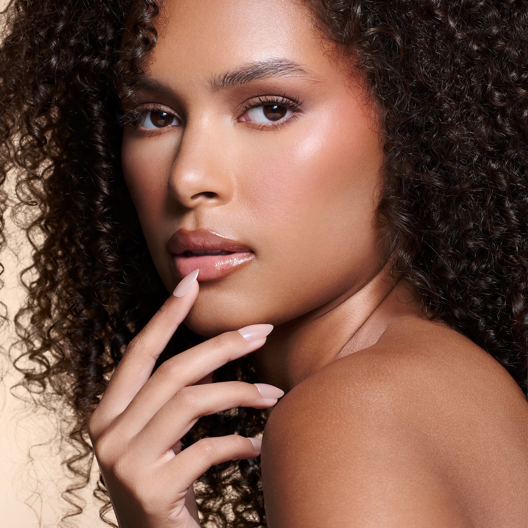 Nailed That Nudie nude with pearl glaze press-on nails by Mani Muse, worn by a model (beauty shot).