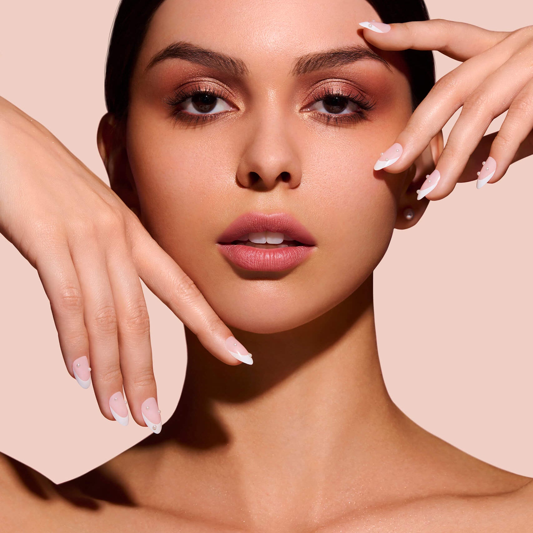 Nice Ice Baby pearls, rhinestones, grommets nail art stickers by Mani Muse, worn by a model (beauty shot).