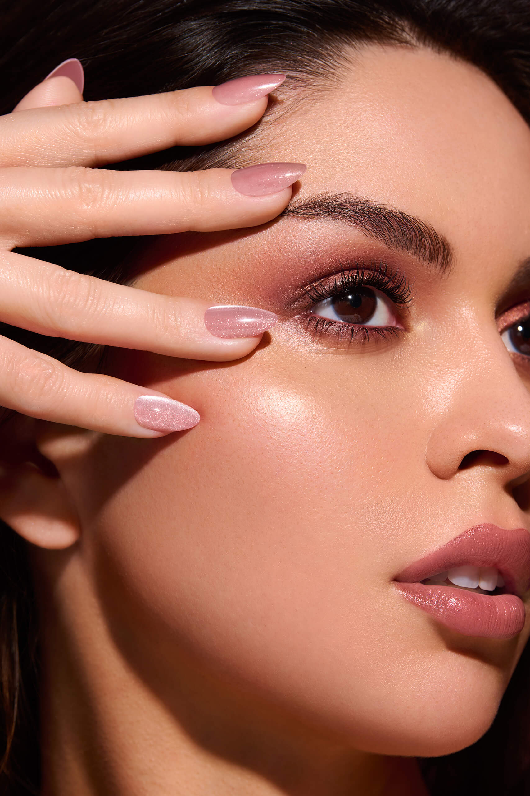 Pinky Blinders rose gold cat-eye press-on nails by Mani Muse, close-up on model.