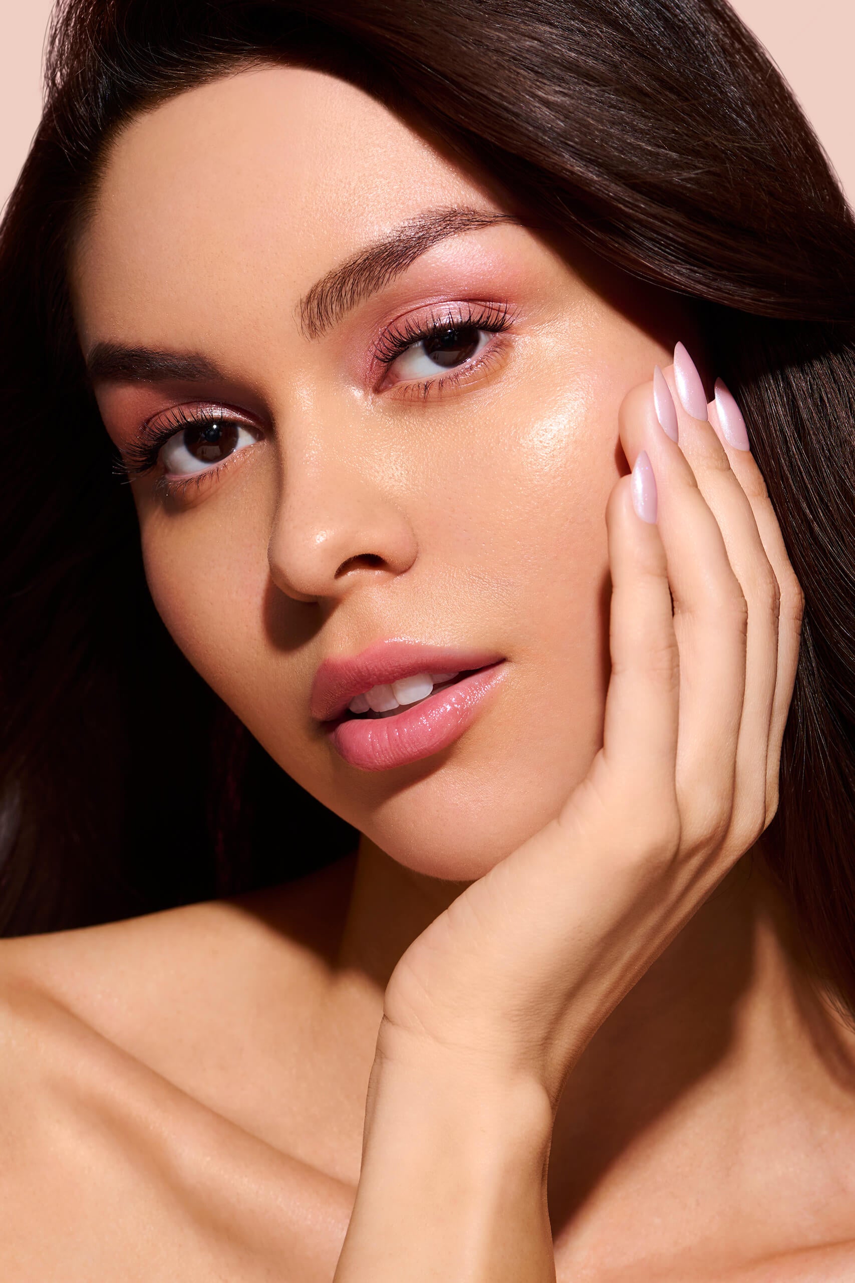 Strawberry Glazed, Ain't Phased strawberry pink glazed press-on nails by Mani Muse, worn by a model (beauty shot).