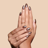 You Choco-alot chocolate brown glazed press-on nails by Mani Muse, close-up hand shot.