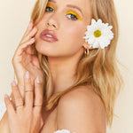 All Damn Daisy nude with daisy accents press-on nails by Mani Muse, close-up on model.