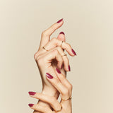 Beet It Creep burgundy press-on nails by Mani Muse, close-up hand shot.