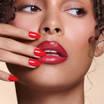 Caught Red Handed red almond press-on nails by Mani Muse, close-up on model.