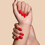 Caught Red Handed red almond press-on nails by Mani Muse, close-up hand shot.