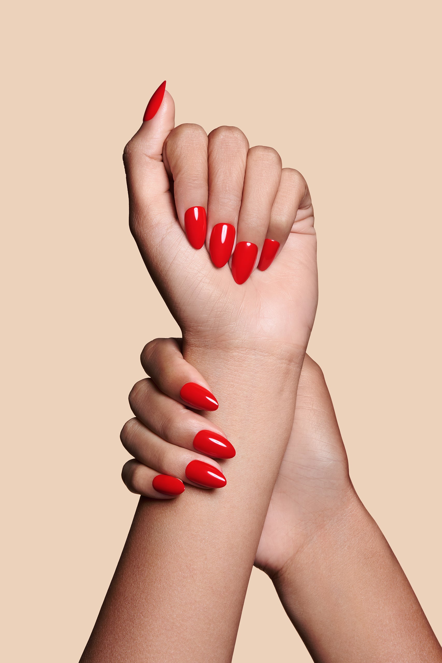 Caught Red Handed red almond press-on nails by Mani Muse, close-up hand shot.