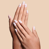 Growing with the Flow nude with 3D petals press-on nails by Mani Muse, close-up hand shot.