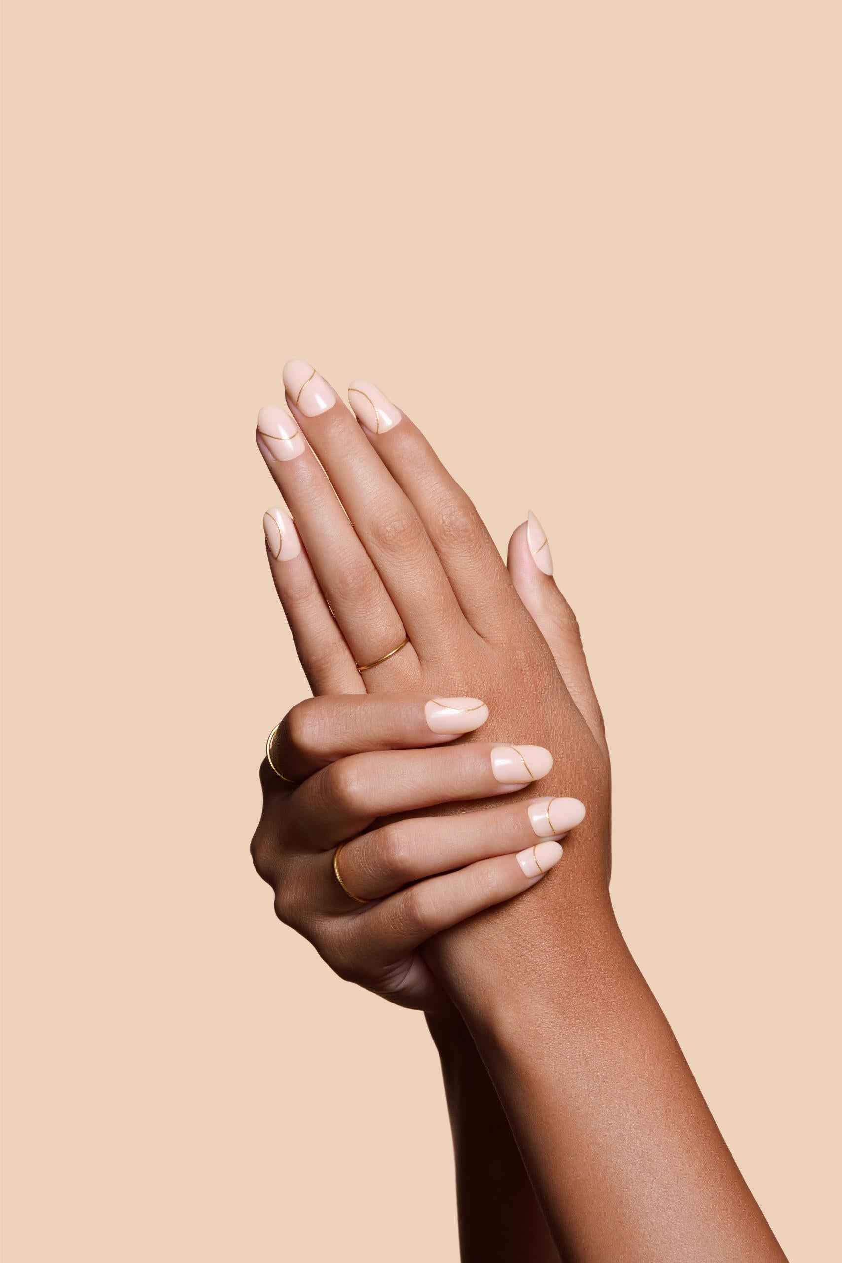 Half Past Nude neutral nude press-on nails by Mani Muse, close-up hand shot.
