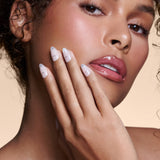 It's The Little Blings silver cat-eye french with chrome press-on nails by Mani Muse, close-up on model.