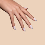It's The Little Blings silver cat-eye french with chrome press-on nails by Mani Muse, close-up hand shot.