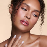 It's The Little Blings silver cat-eye french with chrome press-on nails by Mani Muse, worn by a model (beauty shot).
