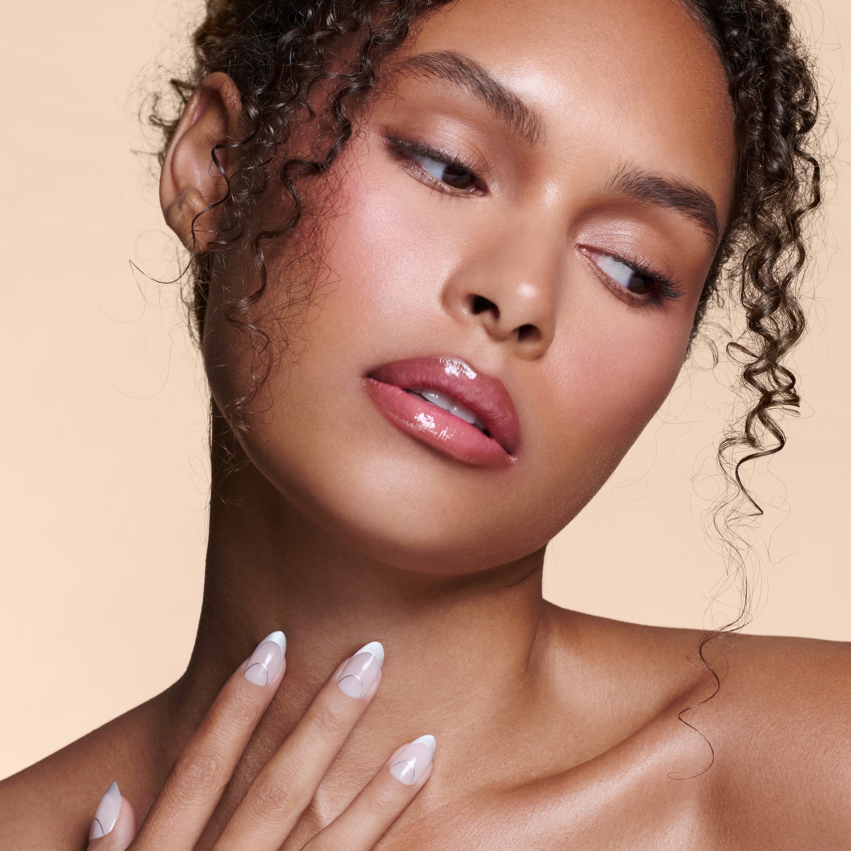 It's The Little Blings silver cat-eye french with chrome press-on nails by Mani Muse, worn by a model (beauty shot).