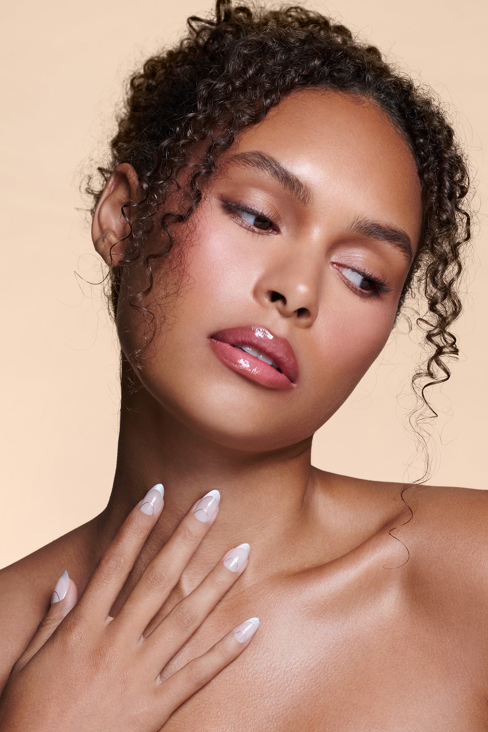 It's The Little Blings silver cat-eye french with chrome press-on nails by Mani Muse, worn by a model (beauty shot).