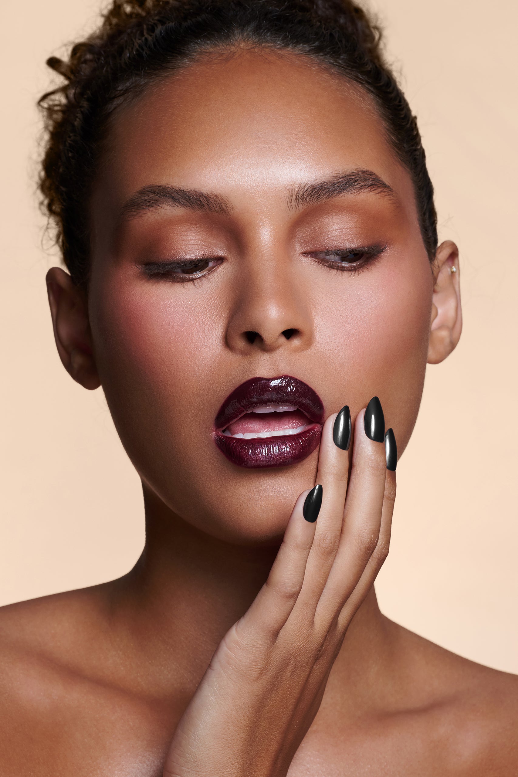 Midnight Night Cap black with pearl gloss press-on nails by Mani Muse, close-up on model.