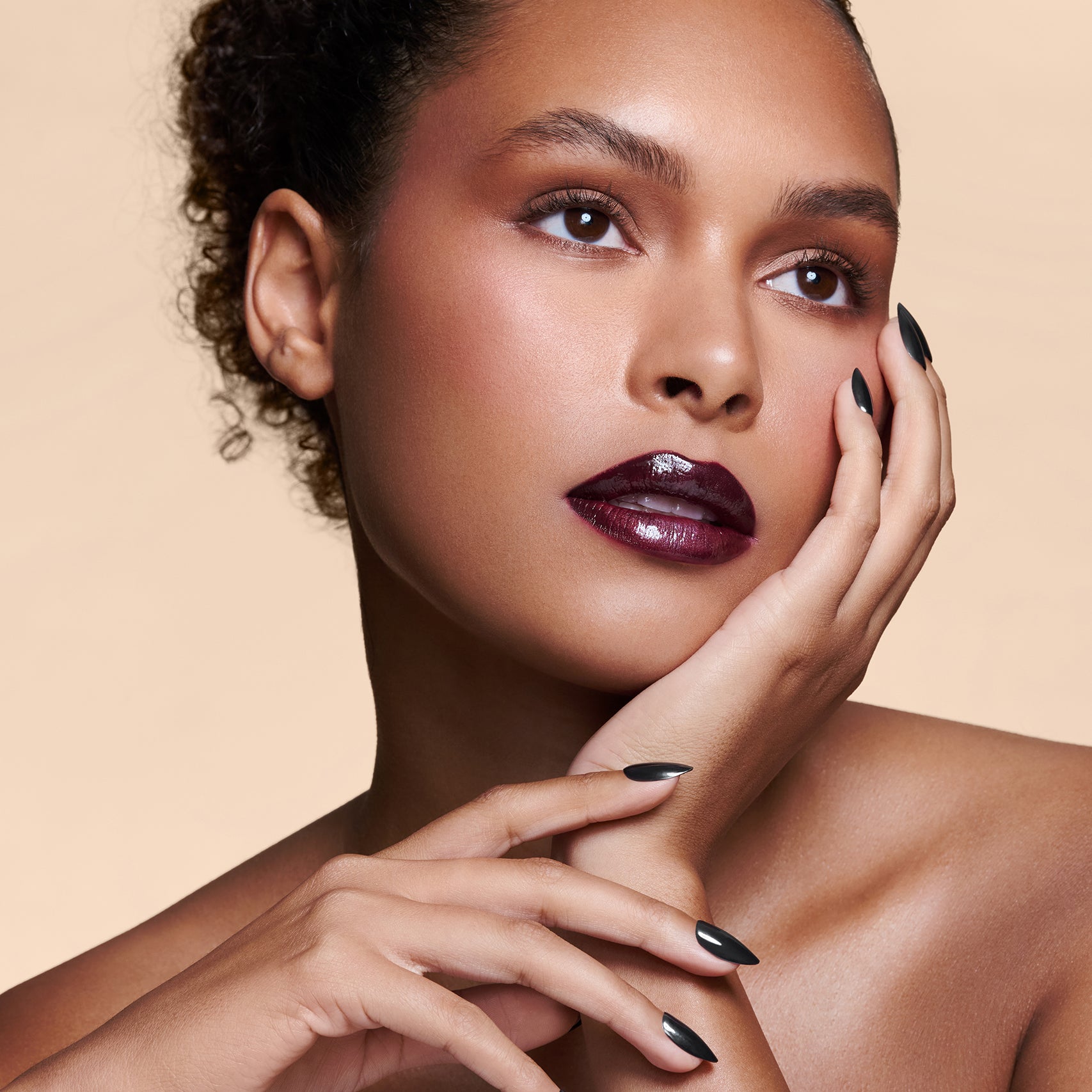 Midnight Night Cap black with pearl gloss press-on nails by Mani Muse, worn by a model (beauty shot).