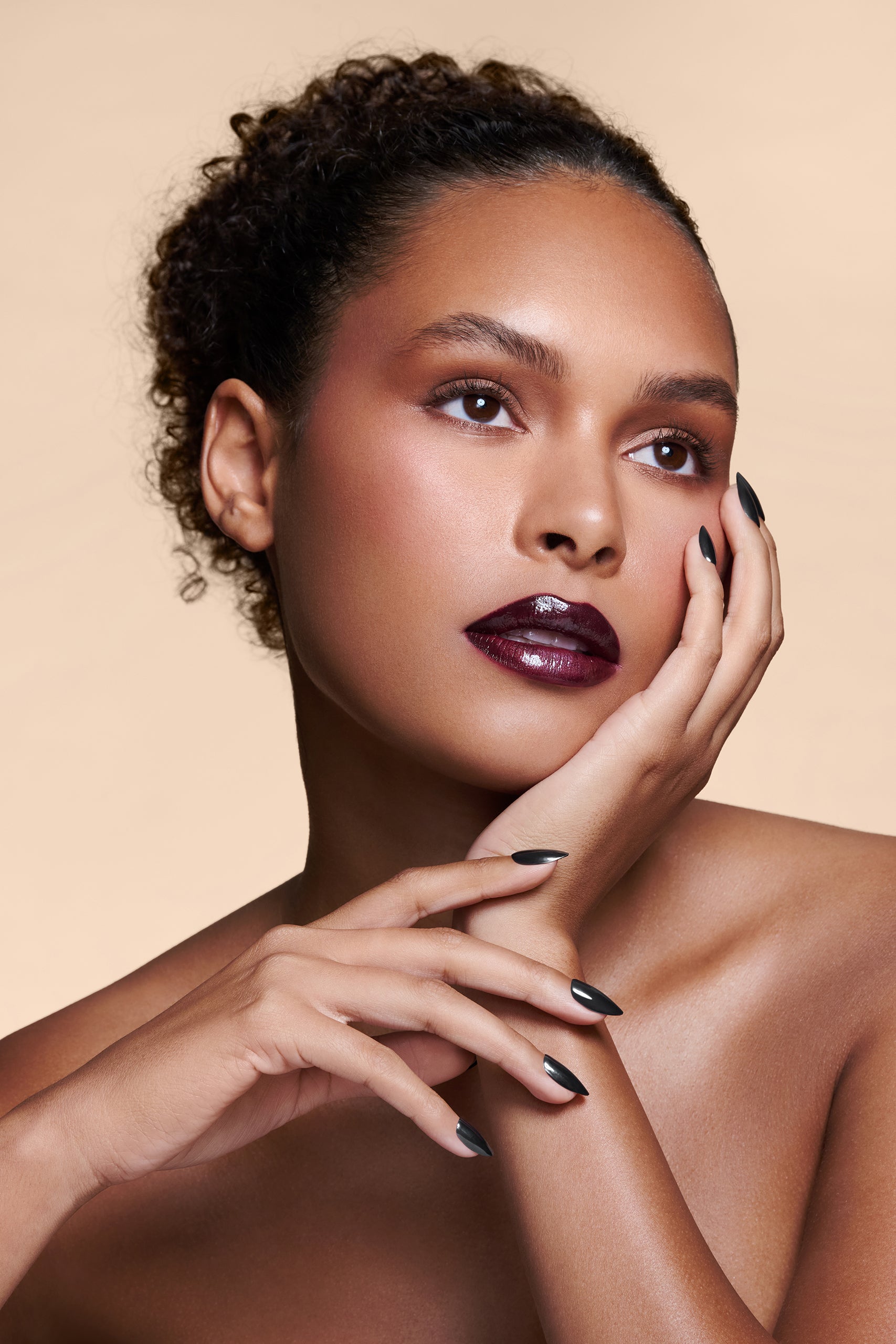 Midnight Night Cap black with pearl gloss press-on nails by Mani Muse, worn by a model (beauty shot).