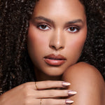 Nail Flex 'N Chill bronze cat-eye press-on nails by Mani Muse, worn by a model (beauty shot).