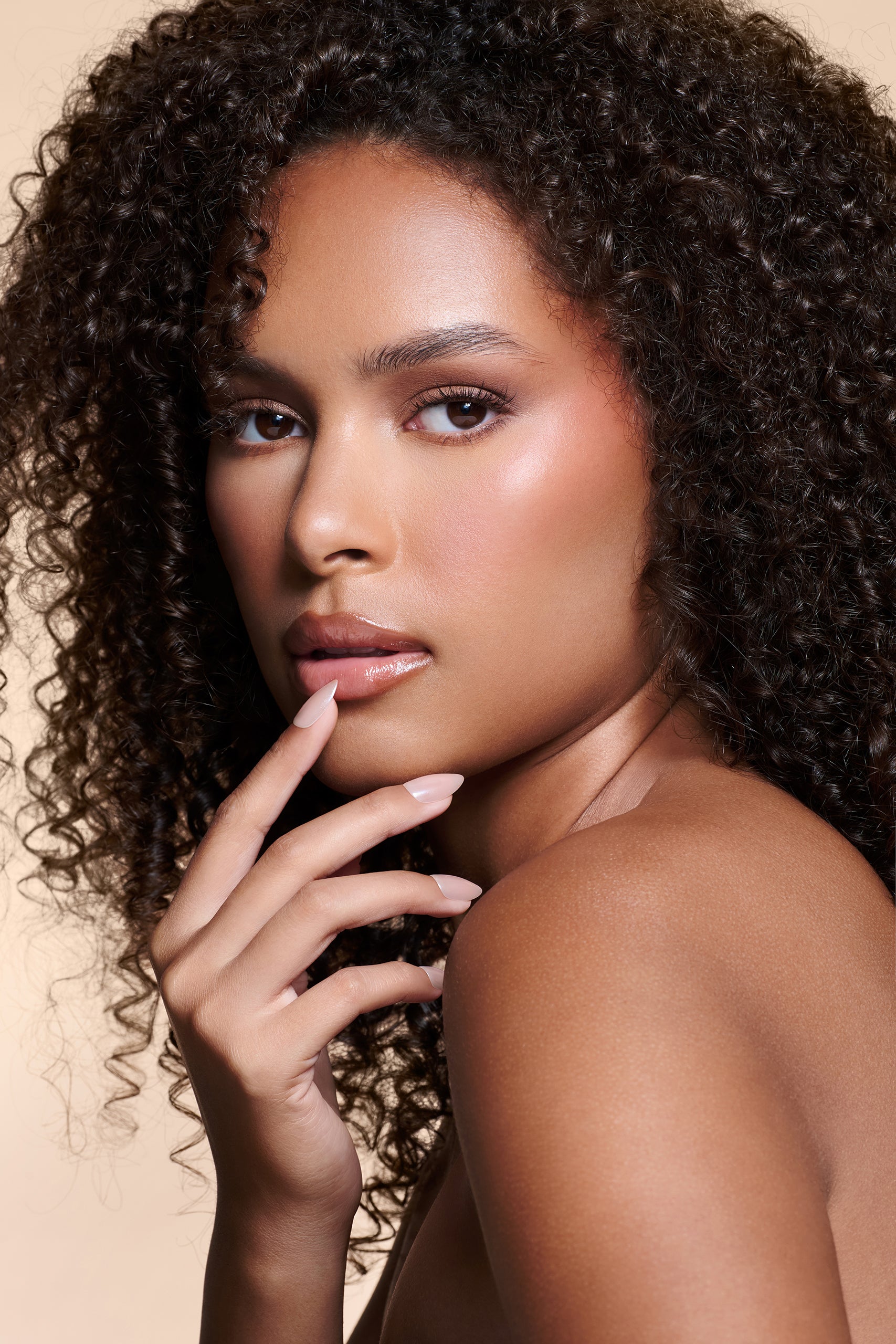 Nailed That Nudie nude with pearl glaze press-on nails by Mani Muse, worn by a model (beauty shot).