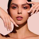 Nice Ice Baby pearls, rhinestones, grommets nail art stickers by Mani Muse, worn by a model (beauty shot).
