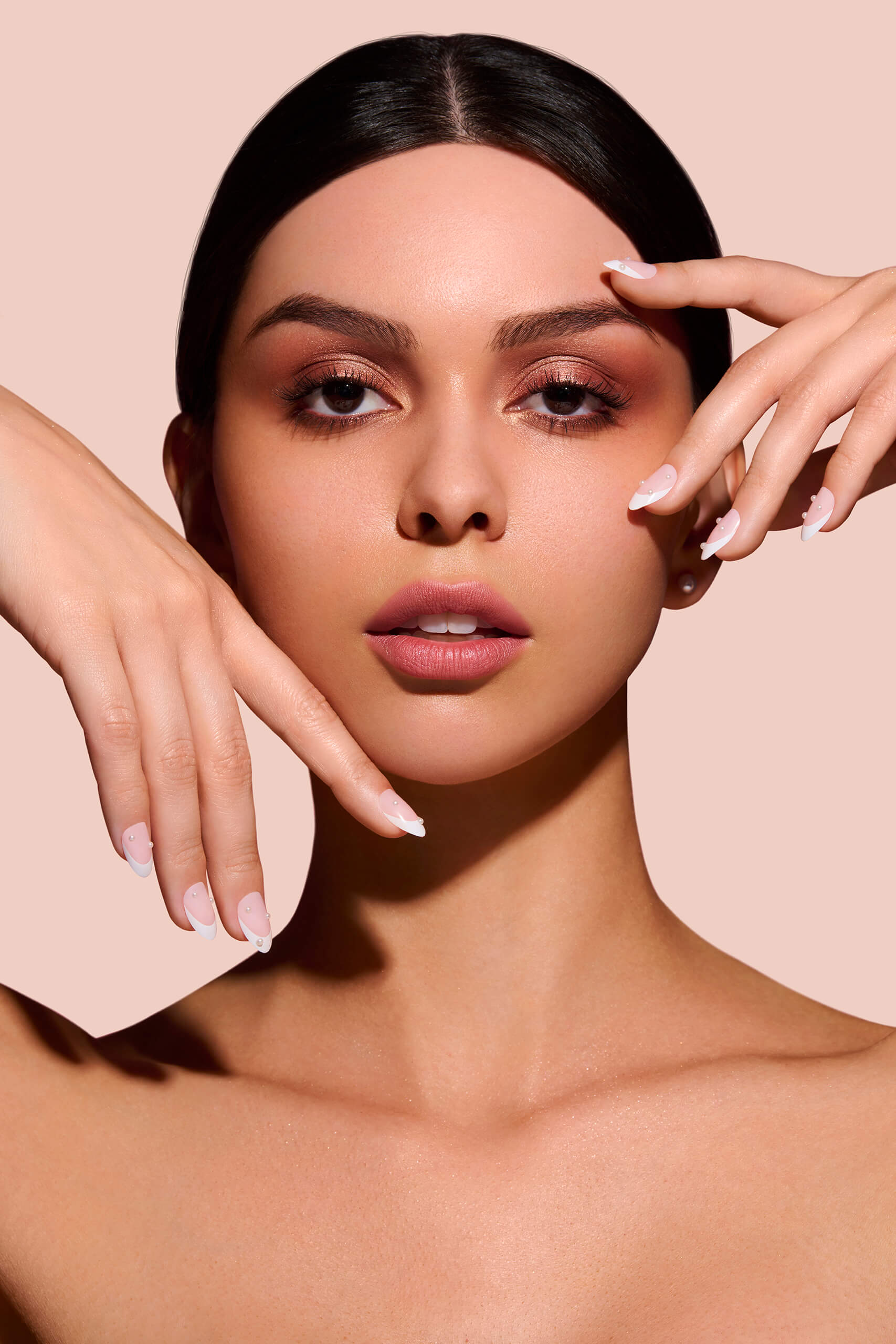 Nice Ice Baby pearls, rhinestones, grommets nail art stickers by Mani Muse, worn by a model (beauty shot).
