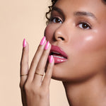 Pink To Make 'Em Wink hot pink glazed press-on nails by Mani Muse, close-up on model.