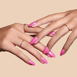 Pink To Make 'Em Wink hot pink glazed press-on nails by Mani Muse, close-up hand shot.