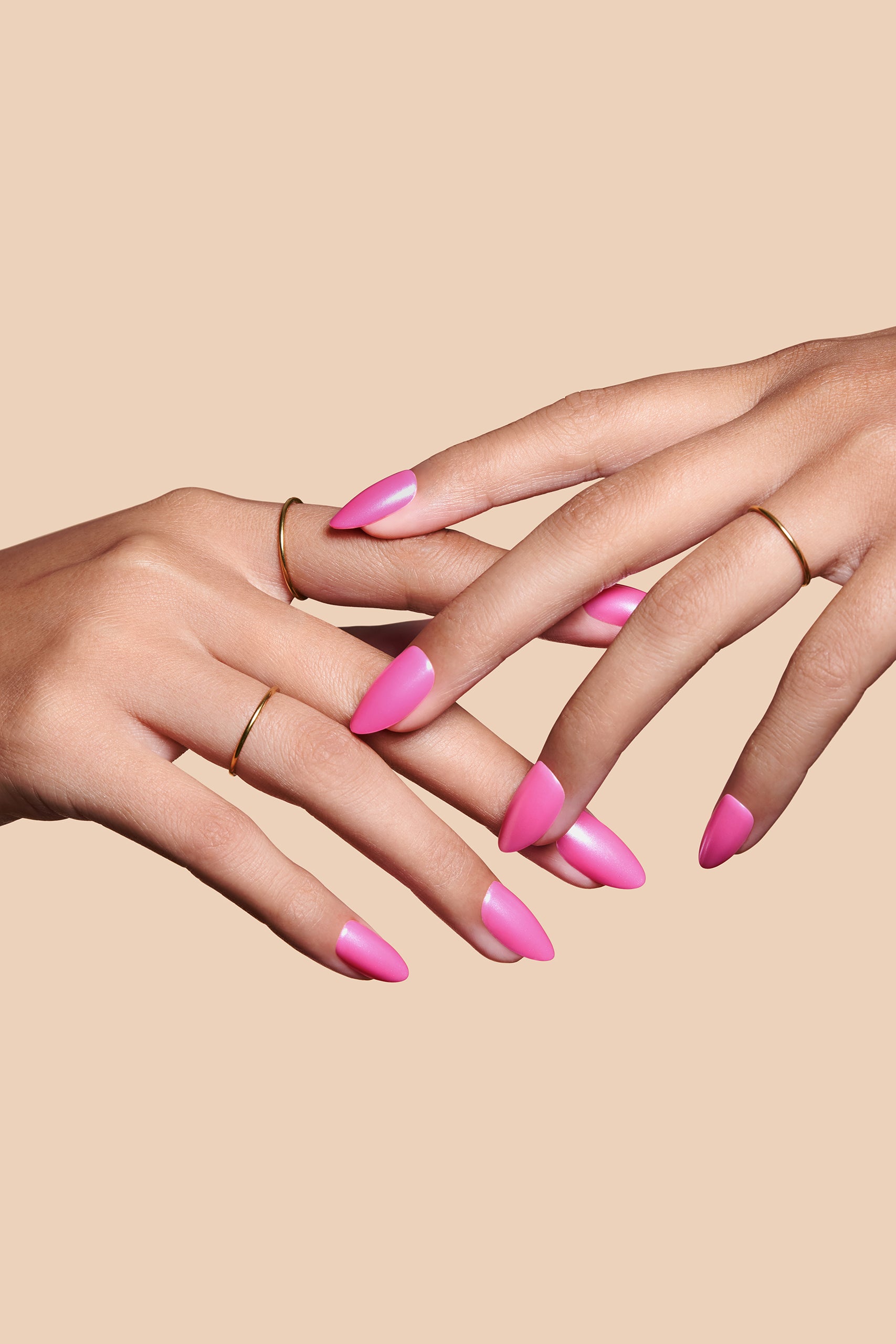 Pink To Make 'Em Wink hot pink glazed press-on nails by Mani Muse, close-up hand shot.