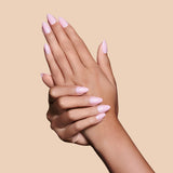 Powder Room Chic powder pink press-on nails by Mani Muse, close-up hand shot.