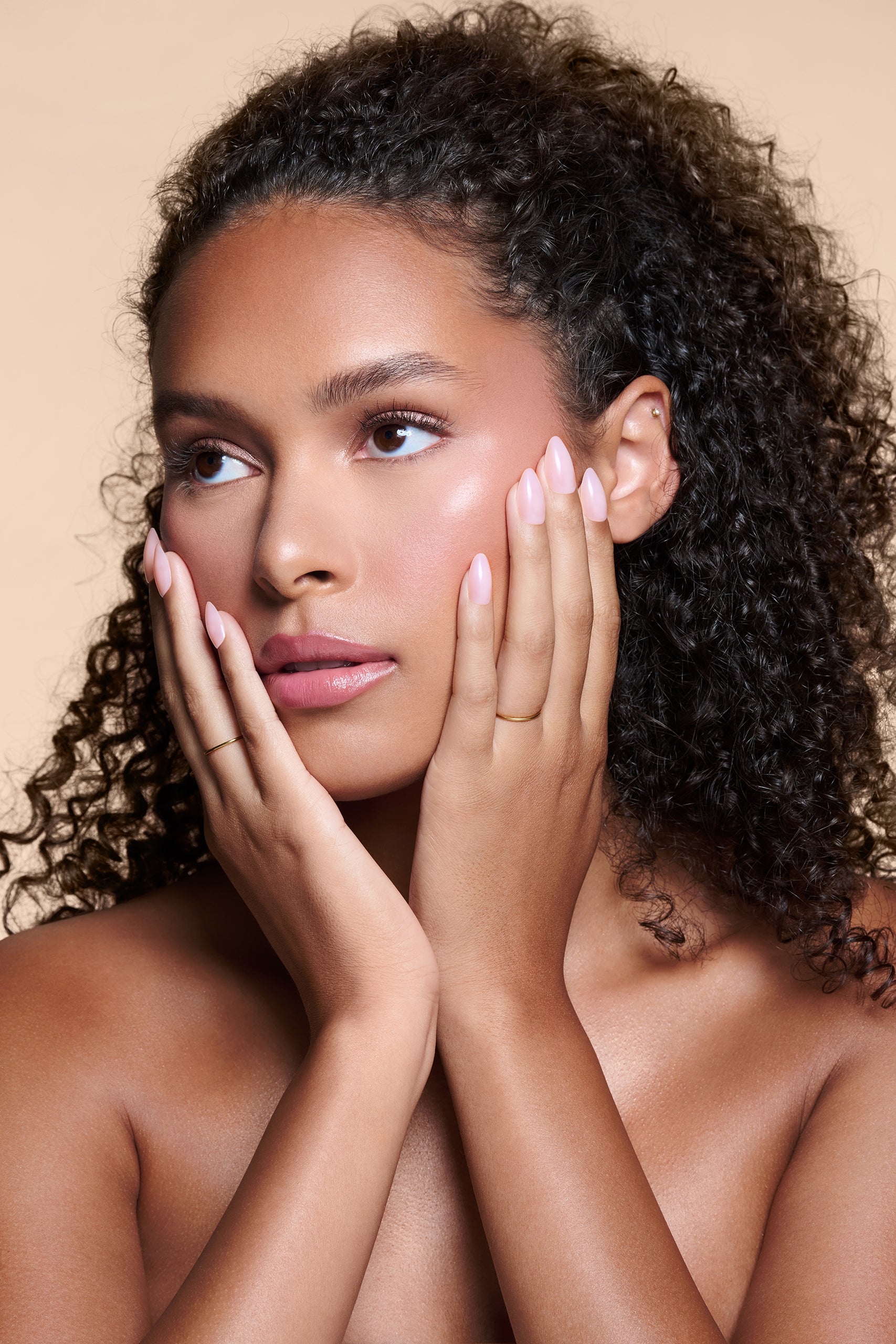 Sheer Thing semi-sheer pink press-on nails by Mani Muse, worn by a model (beauty shot).