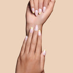 Upsy-Daisy yellow french tips with daisy accents press-on nails by Mani Muse, close-up hand shot.