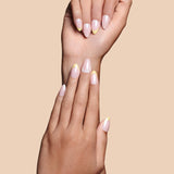 Upsy-Daisy yellow french tips with daisy accents press-on nails by Mani Muse, close-up hand shot.